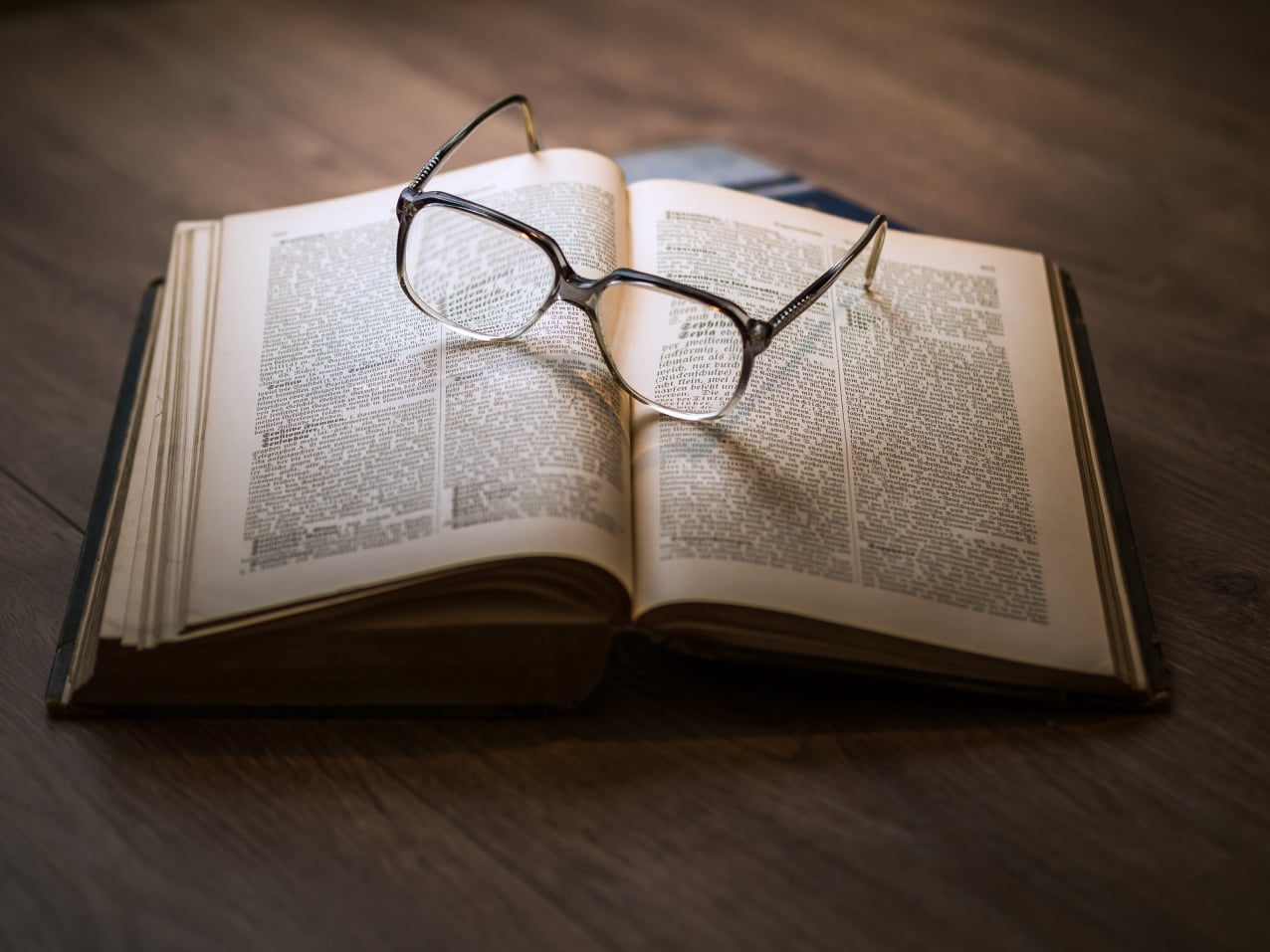 Open book and reading glasses